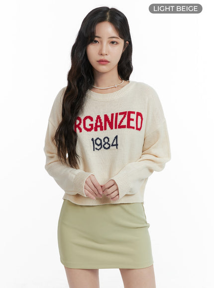 graphic-lettering-round-neck-knit-sweater-om425 / Light beige